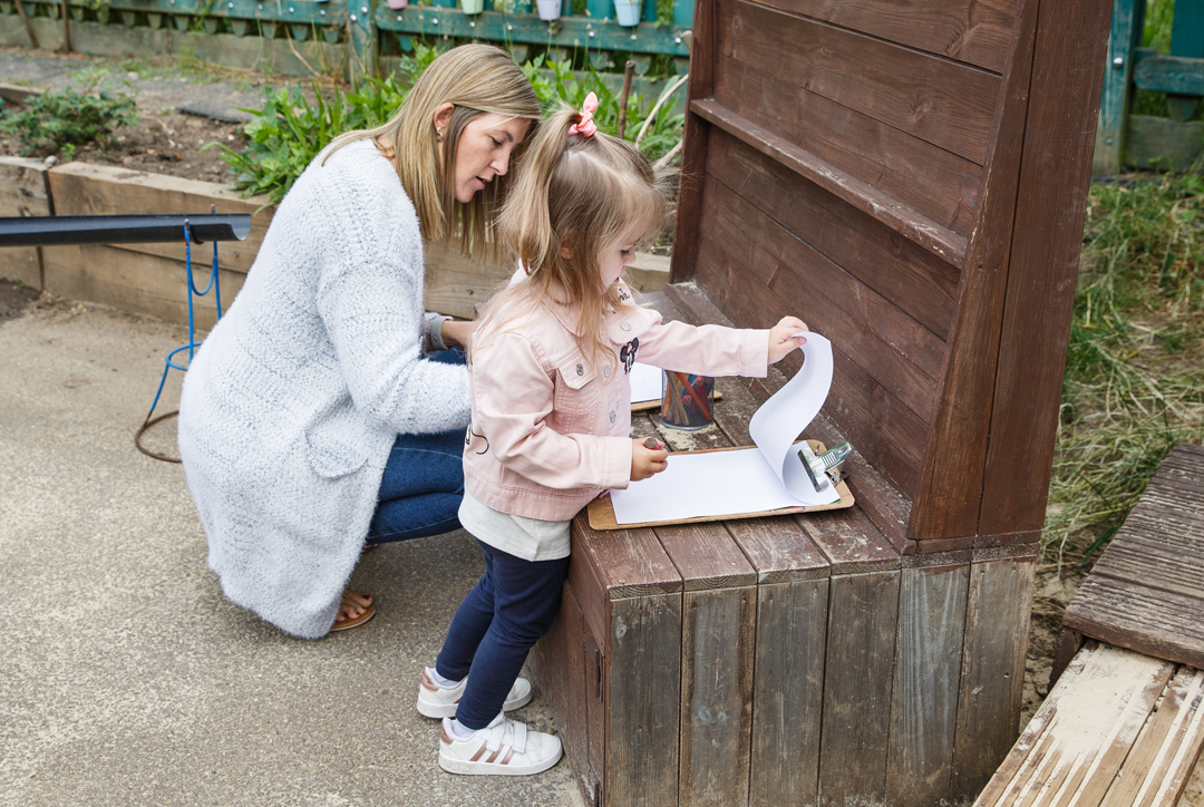 Early Years child outside with an adult