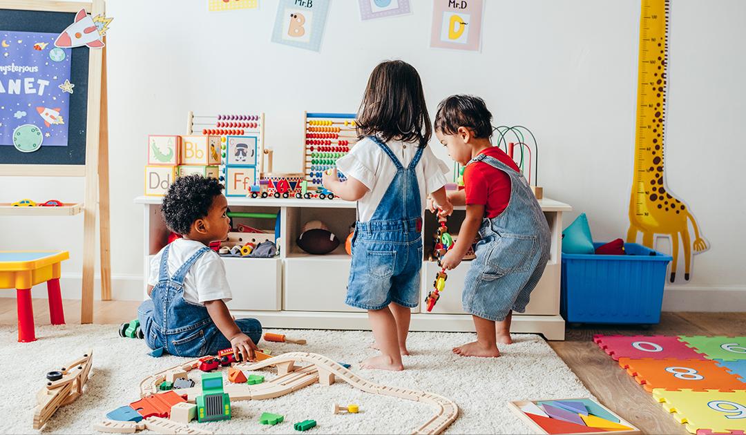Children playing together, surrounded by toys