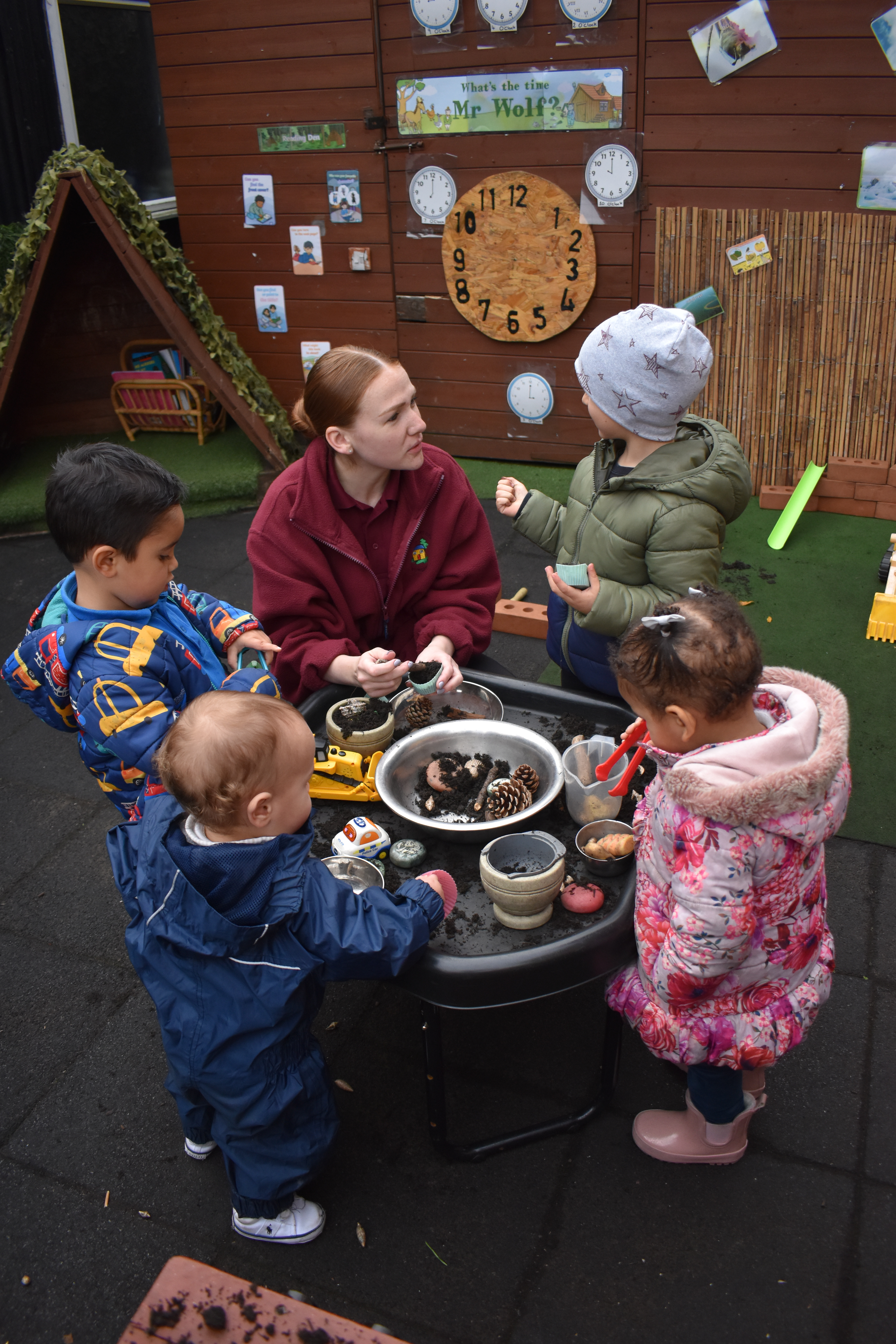 Adult with Early Years children in an outside setting