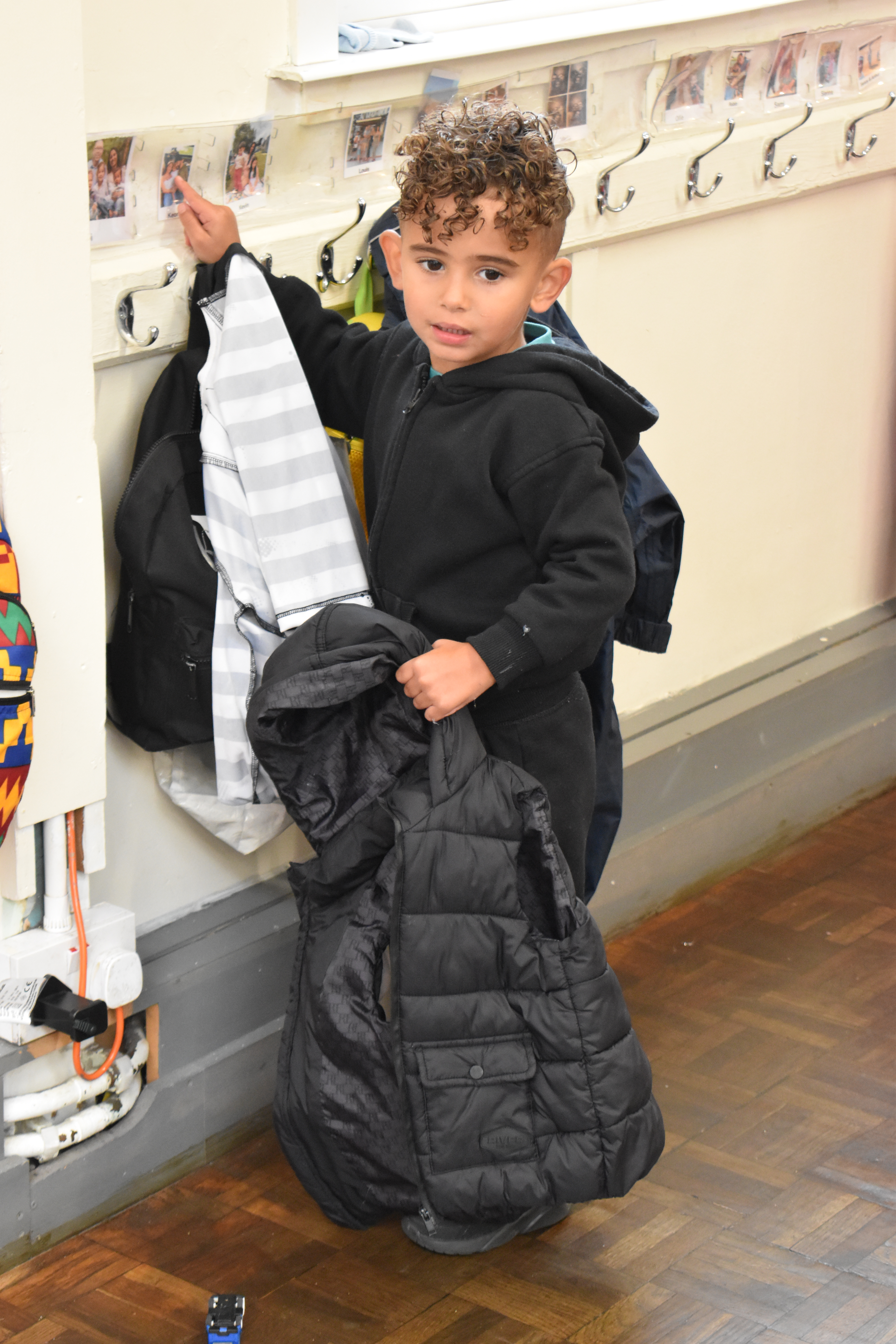Child pointing in an image above a peg