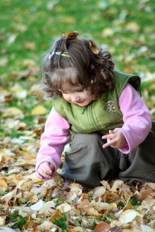 Girl playing with leaves