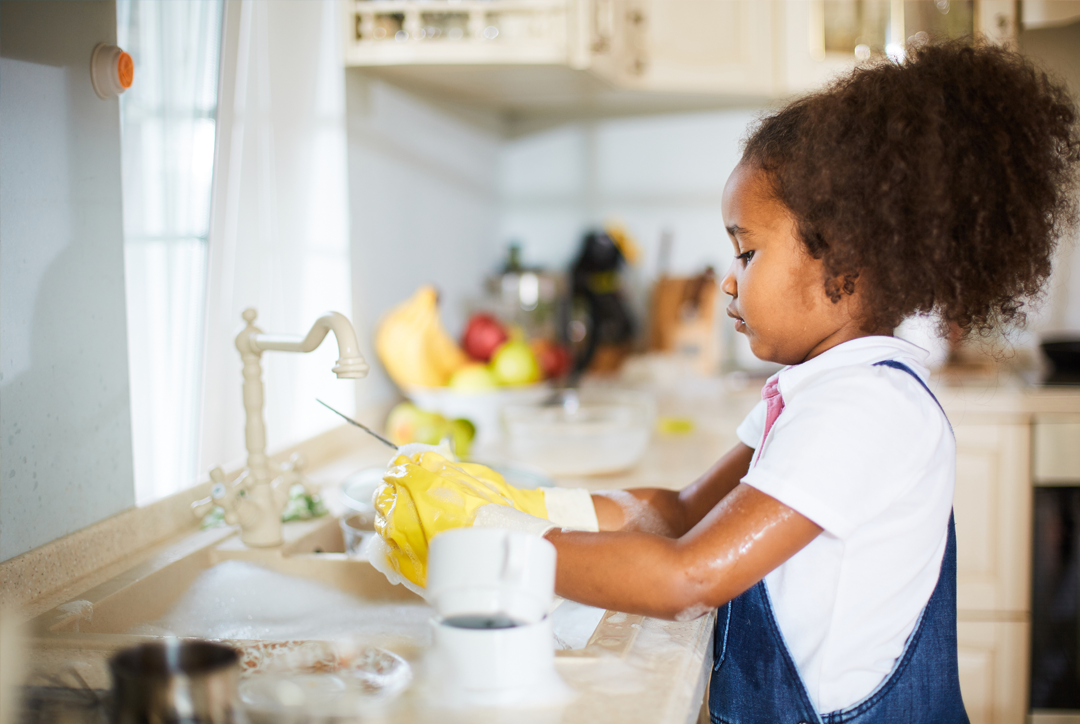 Early Years girl washing up