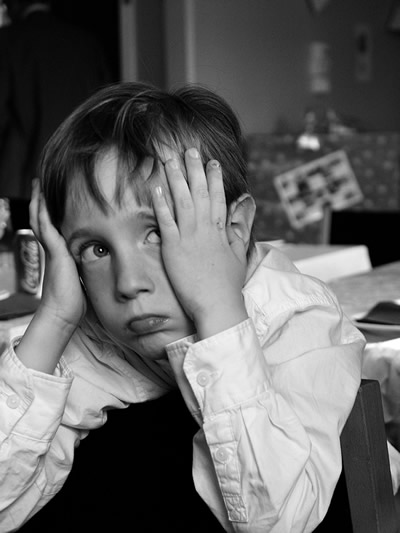 b and w photo of child covering their ears