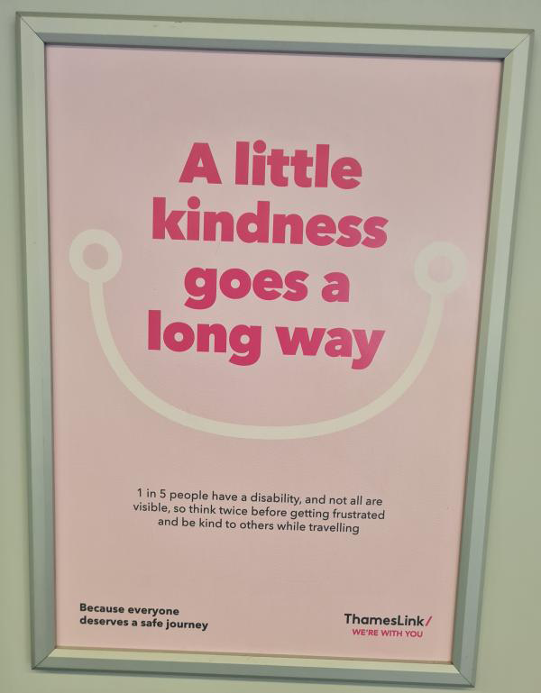 Sign in interior of train: "a little kindness goes a long way"