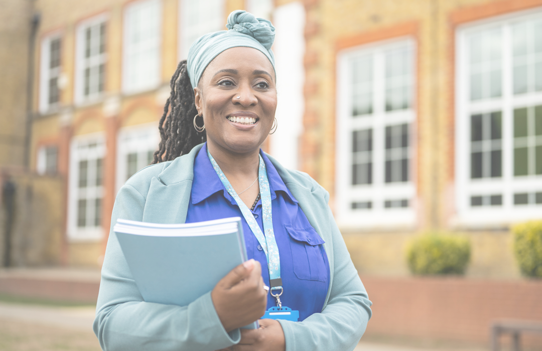 Happy woman wearing blue infront of a building