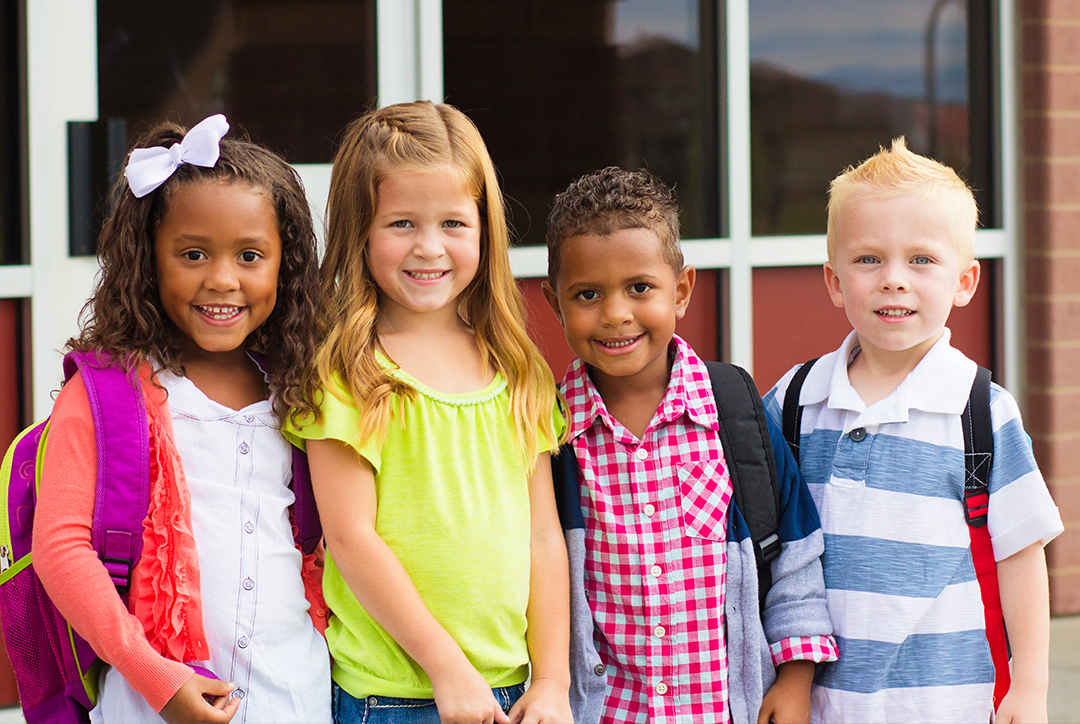 Happy looking Early Years children together