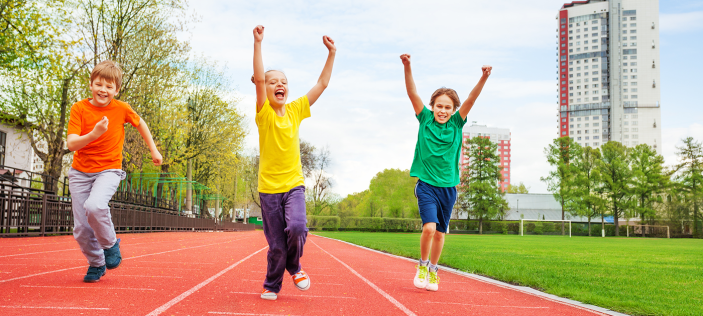 children jumping on an athletics track