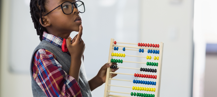 child looking at abacus