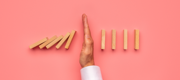 Dominoes being stopped by hand