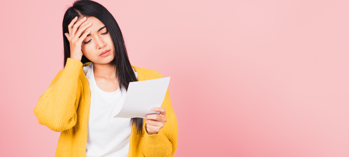 Woman in yellow cardigan looking stressed