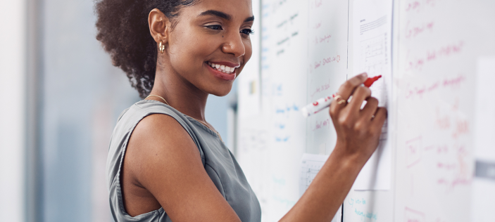 Person writing on whiteboard