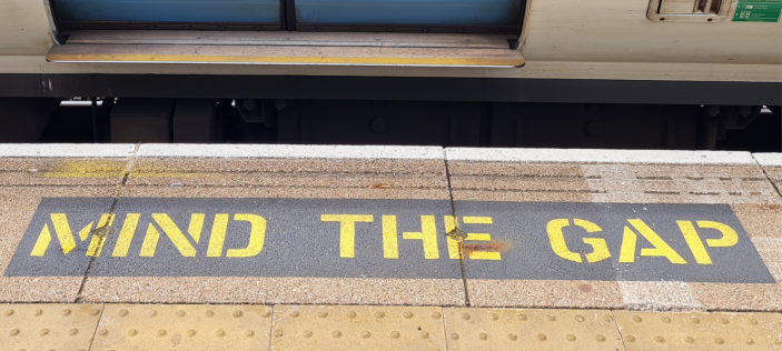 "Mind the gap" text on train station platform 