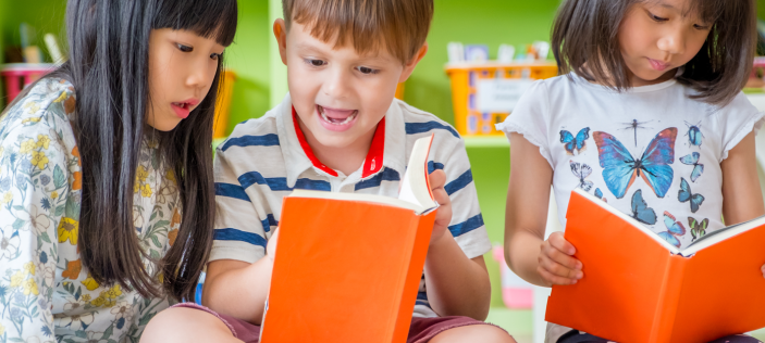2girls and a boy reading