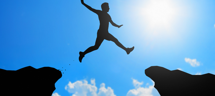 man leaping agaisnt blue sky