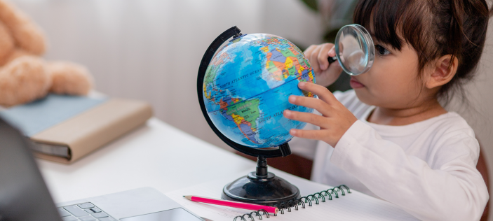Girl looking at globe