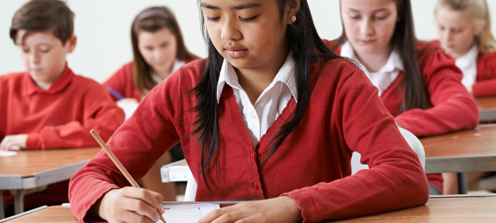 children in classroom in red uniform