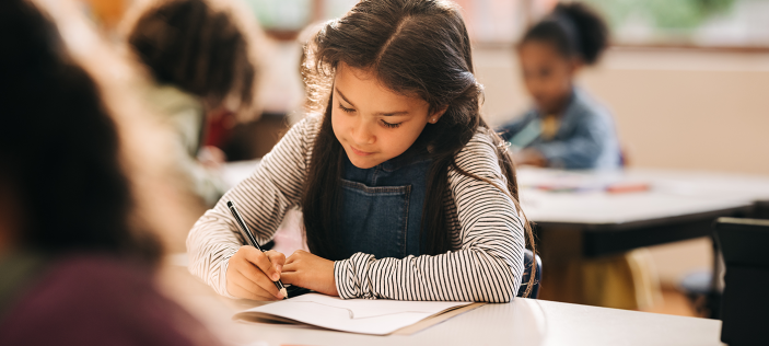 School girl writing in book