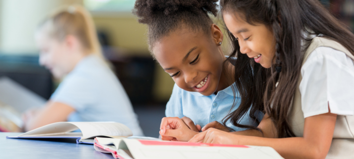 Pupils reading together in class