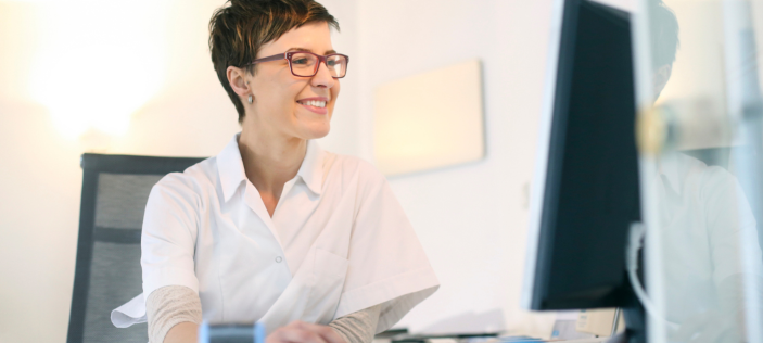 Smartly dressed person looking at computer screen