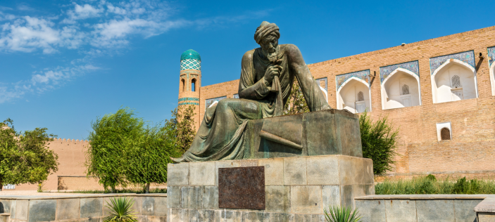 Statue in front of building and blue sky