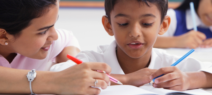 Teacher and child, writing together