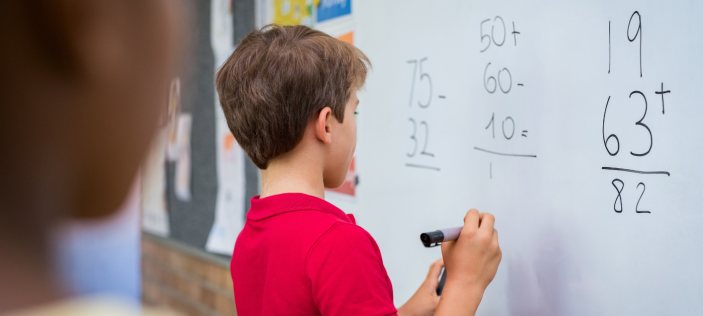 Child writing on whiteboard