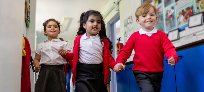 Early Years children in red school uniform
