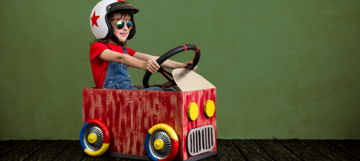 Boy riding in a small play-car