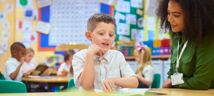 Educator with child in classroom