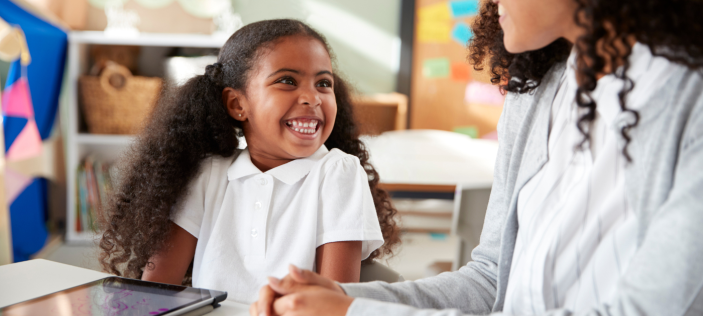 female teacher with little girl