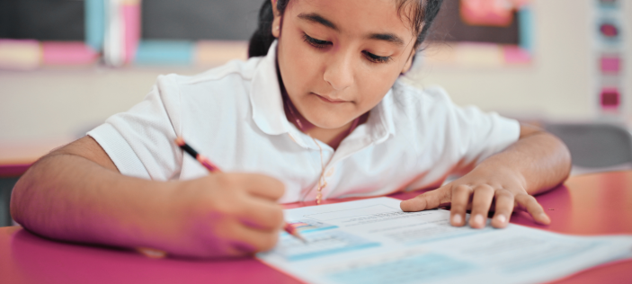 Girl writing with pencil