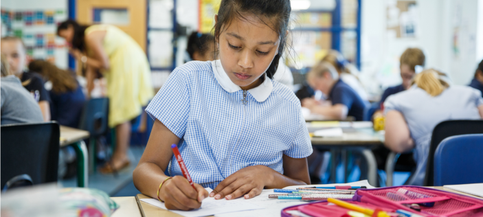 School girl writing in book