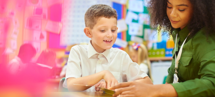 Woman in green shirt helping a school pupil