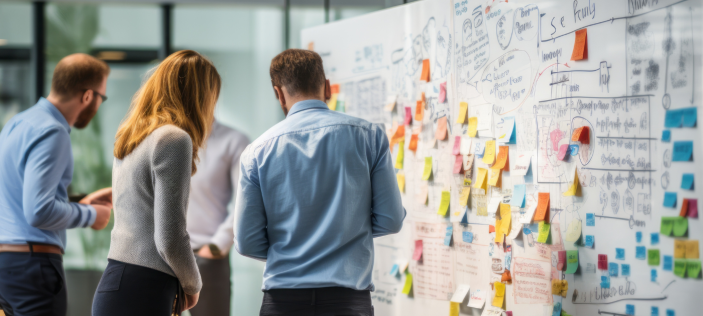 Adults looking at a board full of post-it notes
