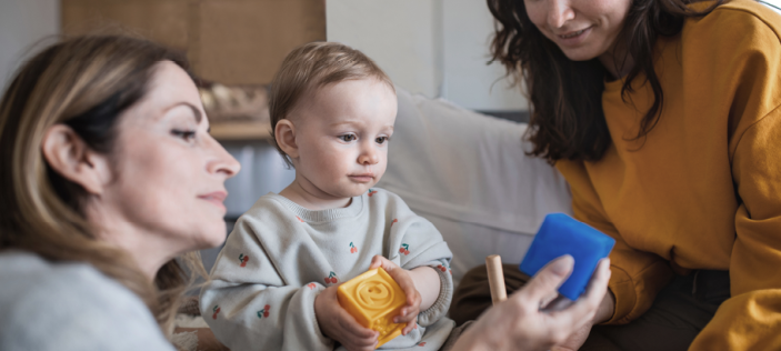 Women with an Early Years child looking at something blue