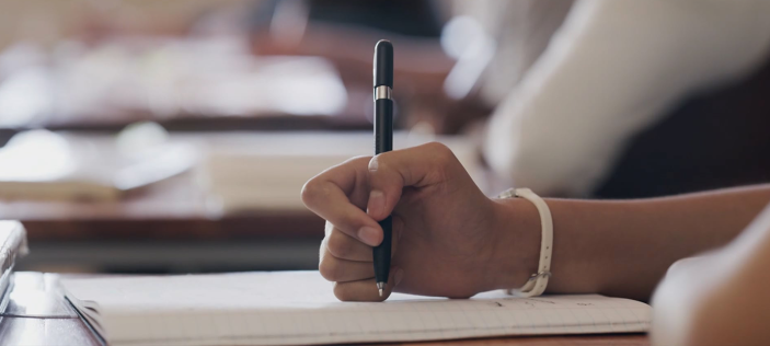 Hand holding a pen
