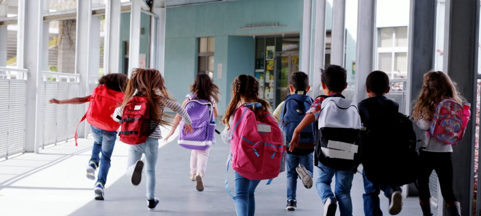 Children running together in a halway