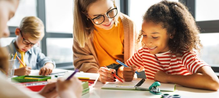 Teaching assistant helping pupils