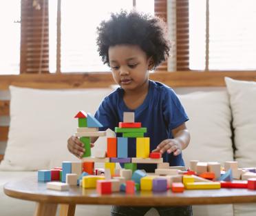 Boy playing with coloured bricks