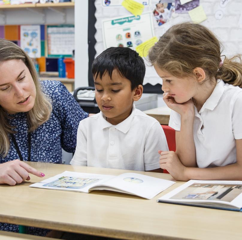 teacher with 2 children reading