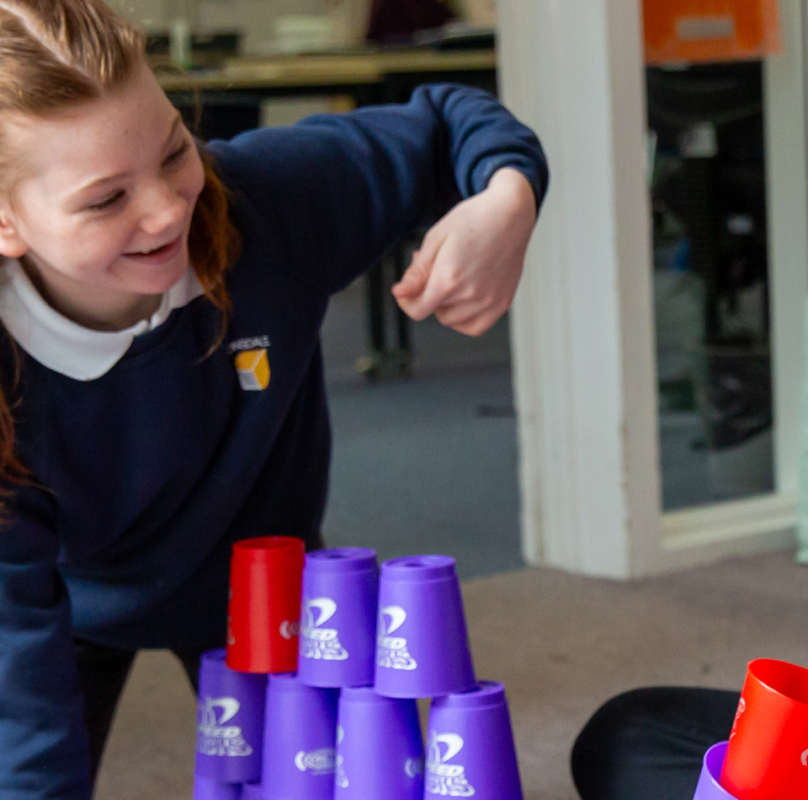 boy and girl playing with purple and red cones