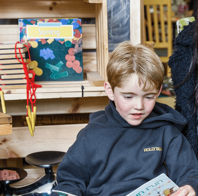 teacher with boy in blue top