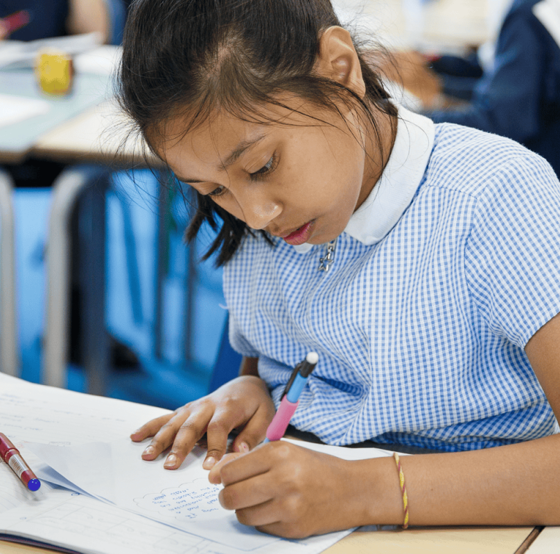 girl in blue uniform writing