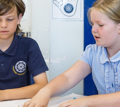 boy and girl working together in classroom