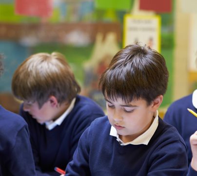 children in classroom in blue uniform