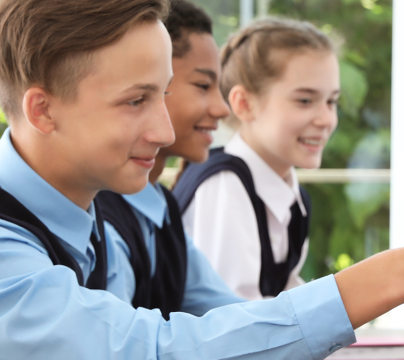 2 girls and a boy looking a computer screens