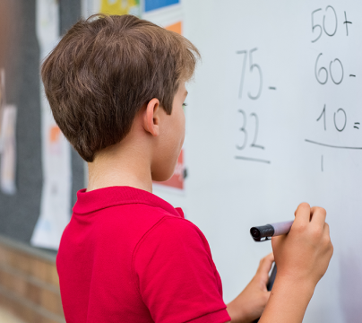 Child writing on whiteboard