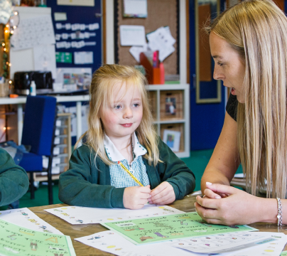 teacher with 2 girls in a classroom