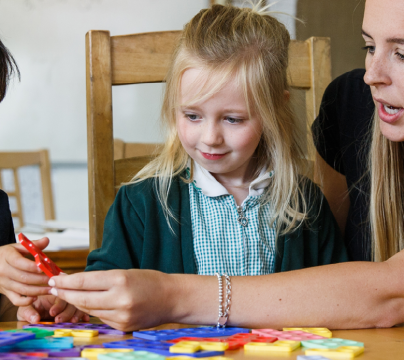 teacher with a boy and girl in reception