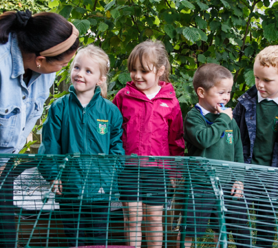 teacher with children outside